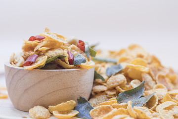 Delicious cereal spicy cornflakes warm tone background. A Breakfast cereal Tom Yum Spicy flavour made by flakes of corn.