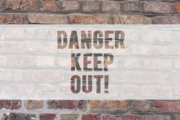 Writing note showing Danger Keep Out. Business photo showcasing Warning be alert stay away from this point safety sign Brick Wall art like Graffiti motivational call written on the wall