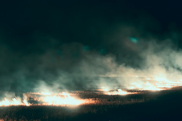 Big fire and a lot of thick smoke. Fire at night