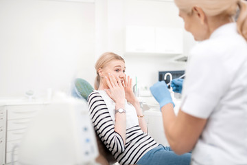 Dentists young patient being scared of dental treatment.