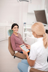 Smiling woman talking to her dentist about the next appointment.