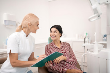 Woman sharing her information with the dentist.