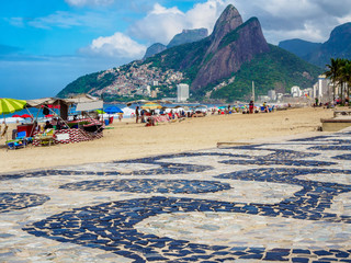 Ipanema beach with mosaic of sidewalk and mountain Dois Irmao (Two Brother)  in Rio de Janeiro,...