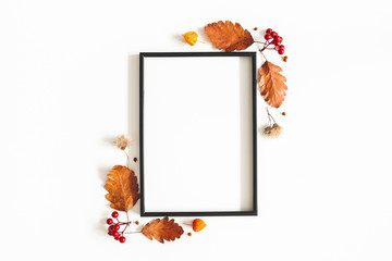 Autumn composition. Photo frame, flowers, leaves on white background. Autumn, fall, thanksgiving day concept. Flat lay, top view, copy space