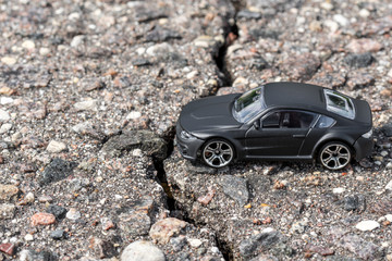 Car beside crack in the pavement