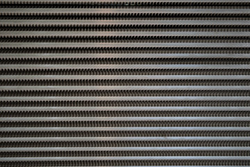 Surface of a latticed metal fence with jagged stripe elements