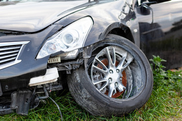 Car in road accident. Close-up of wheel and headlights.