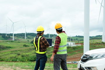 Engineers and supervisors in the wind turbine power industry check the operation system.