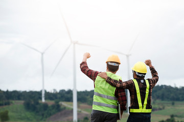 Engineers and supervisors in the wind turbine power industry check the operation system.