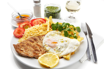 Dish for lunch of fried meat, pork chop with egg, potatoes. Portuguese dish.