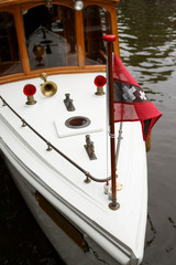 Old fashioned boat in Amsterdam canal.