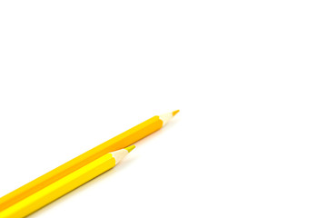 Two yellow pencils on a white background. Selective focus on nearest pencil