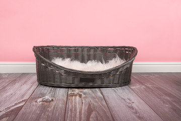 Empty dog bed on a pink background