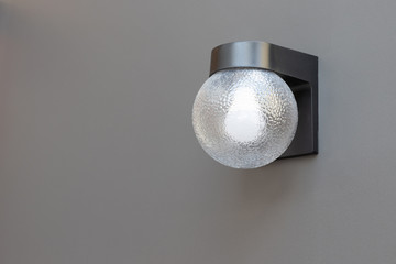outdoor wall lamp on grey concrete panel. exterior lighting.