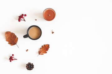 Autumn composition. Cup of coffee, autumn leaves on white background. Flat lay, top view, copy space