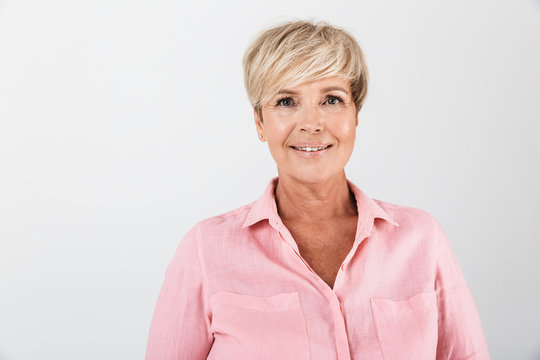 Portrait closeup of beautiful middle-aged woman with short blond hair smiling at camera