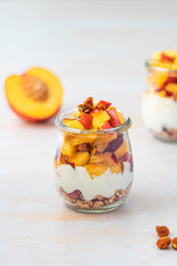 Yogurt with peaches and granola in a weck jar