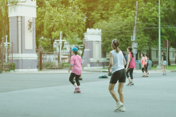 Group of elderly friend doing aerobic dance after work   together at Lumpini Park in Bangkok,...
