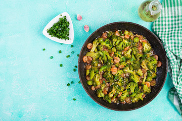 Stir fry shrimp with broccoli close up on a pan. Prawns and broccoli.  Top view, overhead