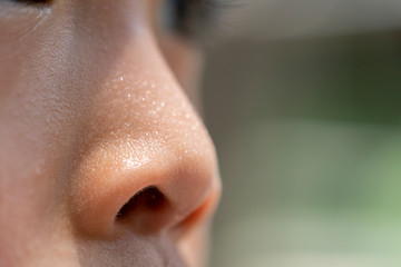 Close up nose of a child, sweat on nose.