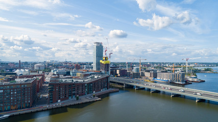 Naklejka premium Construction site. Big industrial tower cranes with unfinished high raised buildings. Modern civil engineering. Contemporary urban landscape.
