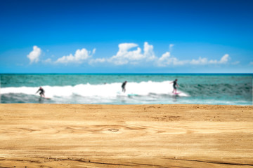 Table background and surfers in the sea view