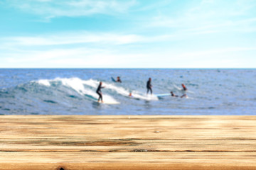 Table background and surfers in the sea view