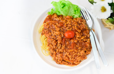 Spaghetti with pork sauce on white table,