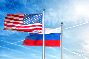 usa and russia national flag waving against clouds blue sky side view of natural color of united states of america us and russian federation state symbols isolated for design copy space template