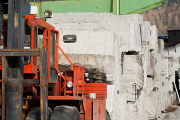 Machinery near large granite blocks