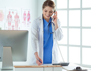 Portrait of a beautiful smiling nurse talking on the phone