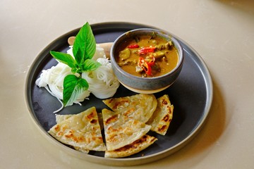 Thai Green Curry with Beef with Fermented rice noodles and roti.