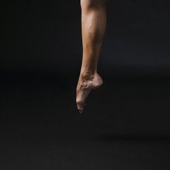 Athletic male jumping on toe