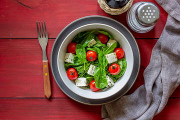 Salad with tomatoes, spinach and cheese. Italian cuisine. Healthy eating. Diet.