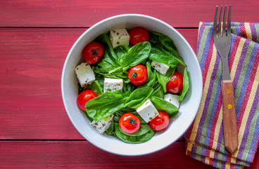 Salad with tomatoes, spinach and cheese. Italian cuisine. Healthy eating. Diet.
