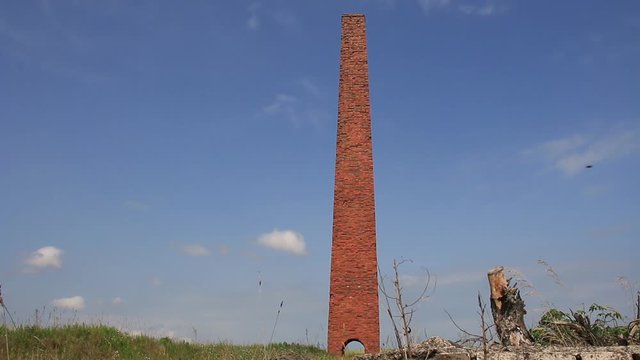 Red Brick Chimney In A Cereal Field.