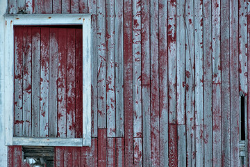 Weathered red wooden wall with window