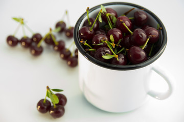 berries ripe red cherries lie in the iron circle and next to it on white background close-up of berries with fresh organic cherries