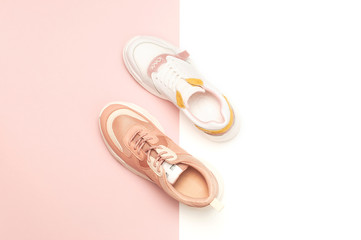 Different female sneakers on white pink background. Fashion blog or magazine concept. Women's...