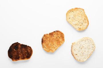 Appetizing slices of fresh bread of different roasts. White background.