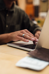 guy working on a laptop in a cafe