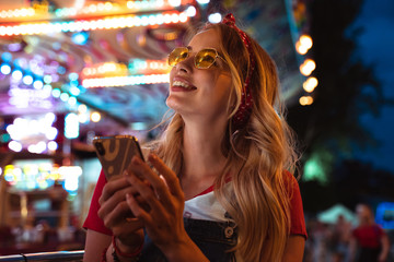 Close up of a cheerful young blonde woman spending time