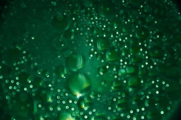 Abstract bubbles dark emerald bokeh background