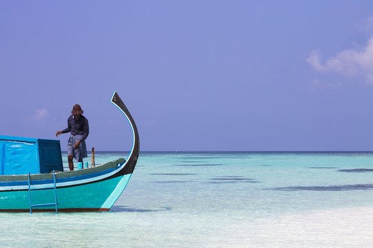 Ari Atoll, Maldives - 25 December 2018: A Maldivian Sailor Is Fishing On His Boat