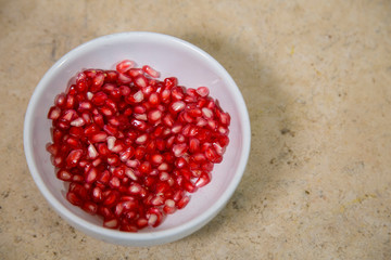 Pomegranate on white plate, ingredient of 