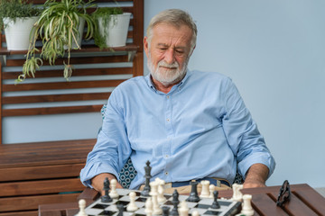 Elderly playing chess in nursing home for leisure