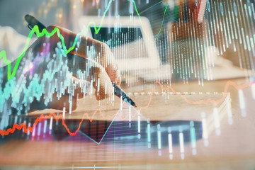 Financial charts displayed on woman's hand taking notes background. Concept of research. Double exposure