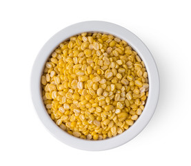 peeled split mung beans in a bowl isolated on white background. top view
