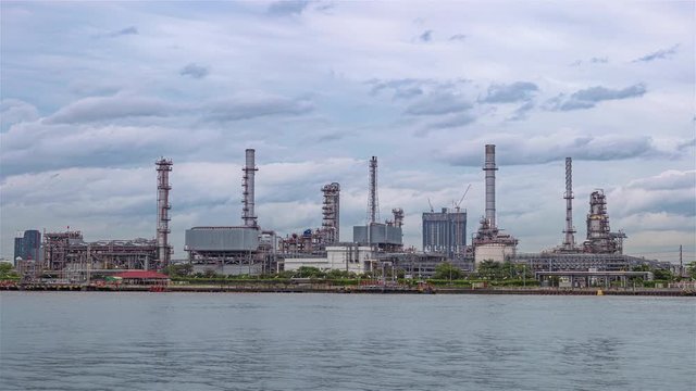 4K (3840p) Energy industry with blue sky background, timelapse technology production of petrol chemical at twilight, Global warming background is save energy and environment concept.