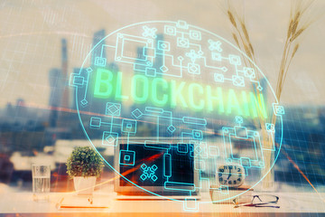 Double exposure of blockchain and crypto economy theme hologram and table with computer background....